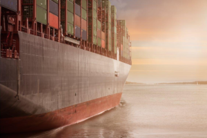 Cargo ship carrying containers through a calm sea